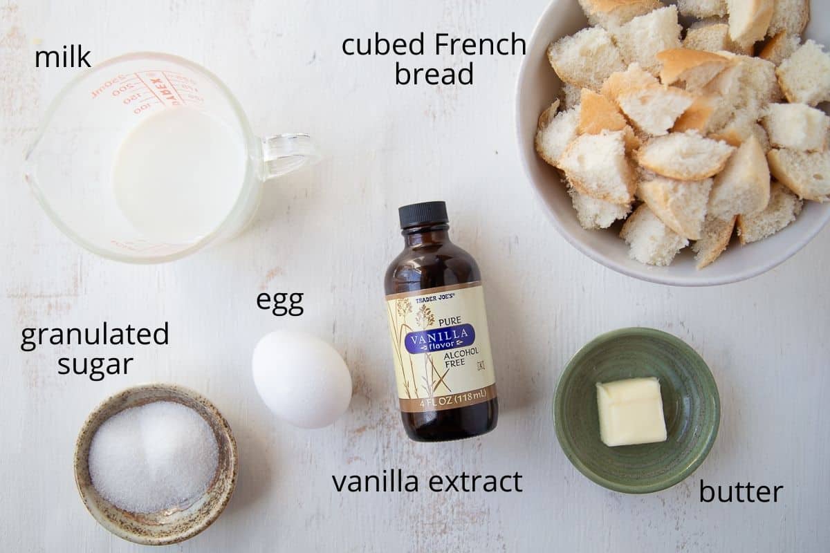ingredients for bread pudding on a white table