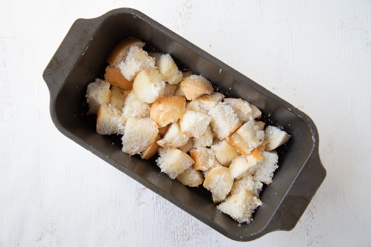 cubed bread in a loaf pan.