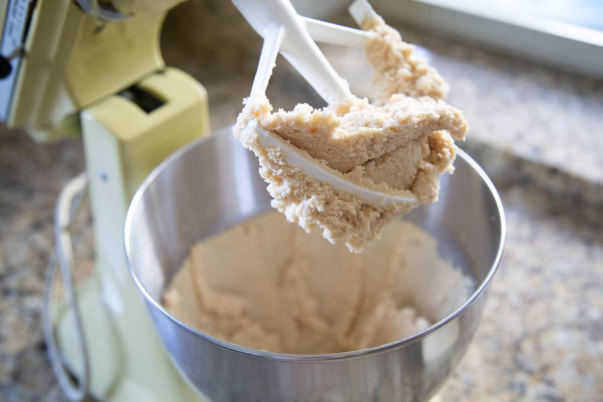 butter and sugar creamed together in a yellow stand mixer with a paddle attachment.