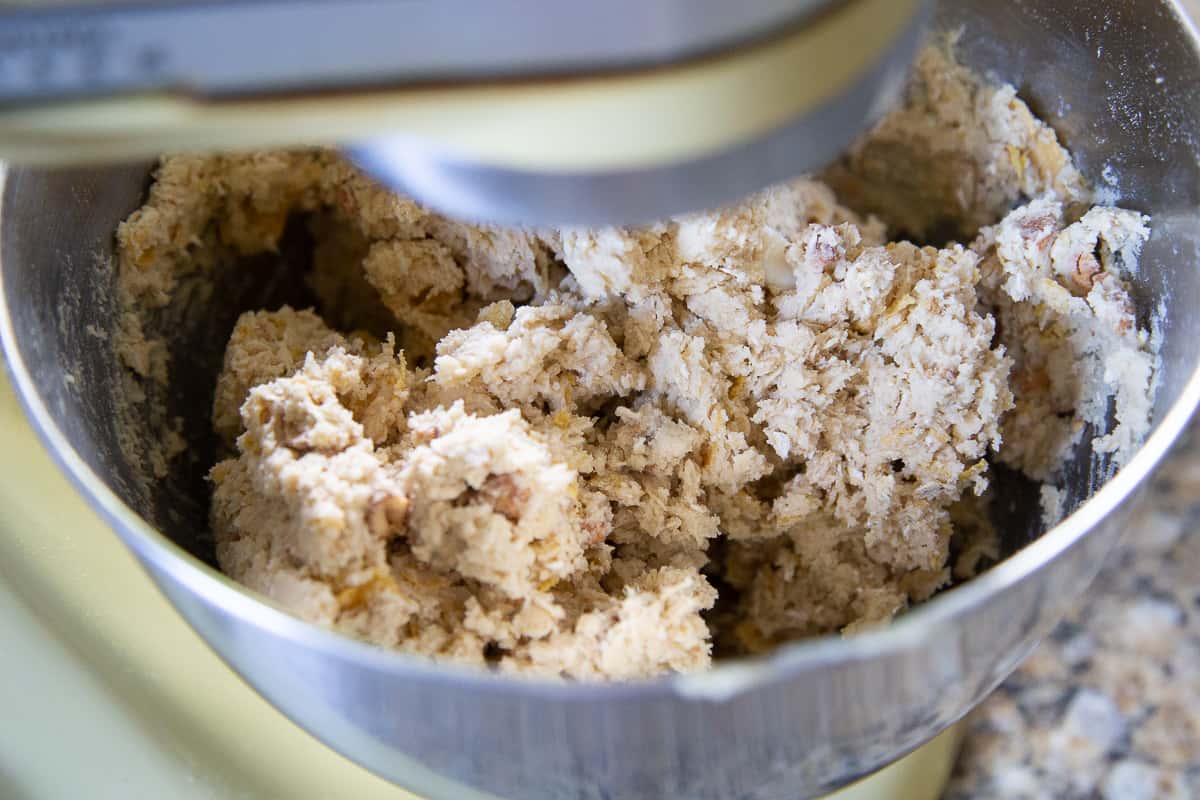 chunky cookie dough in the bowl of a stand mixer.