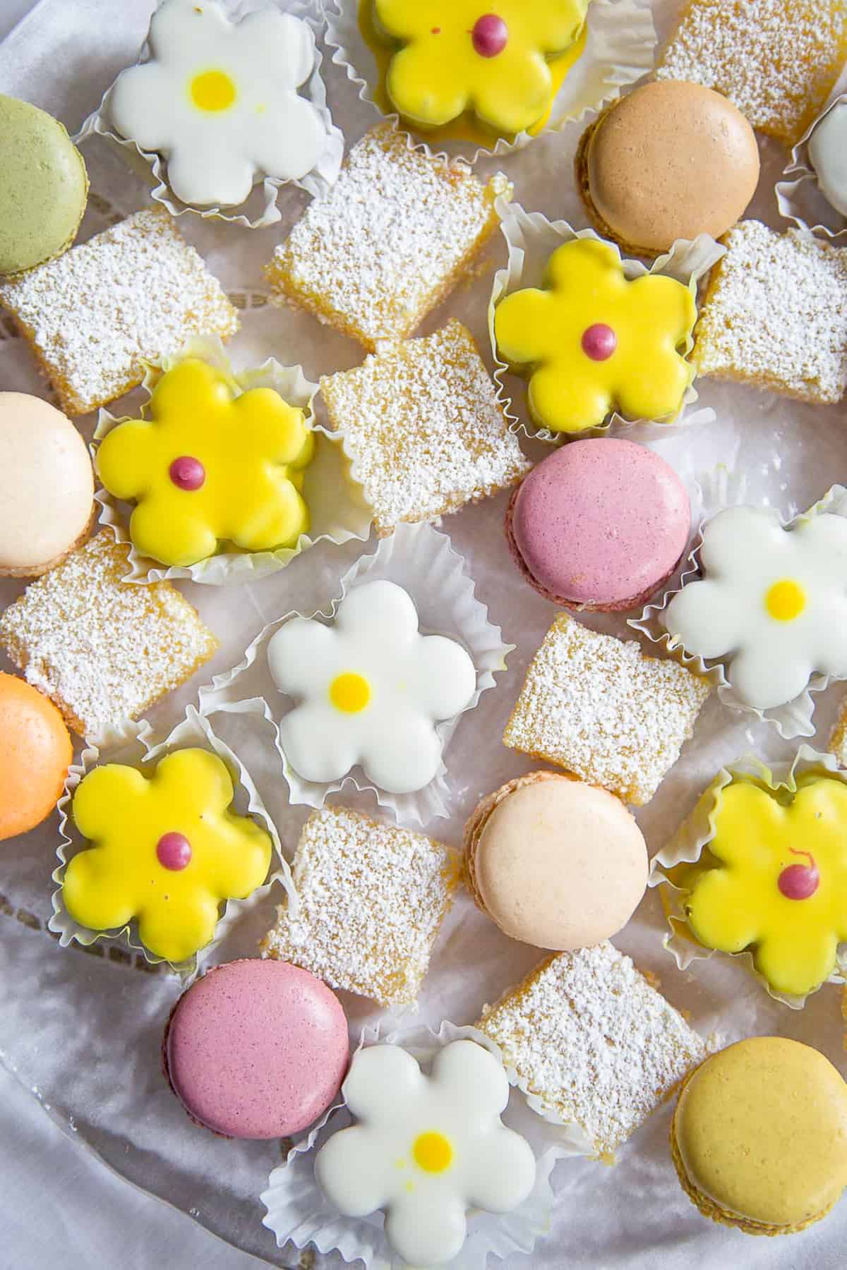 colorful bite-sized desserts on a glass serving platter.