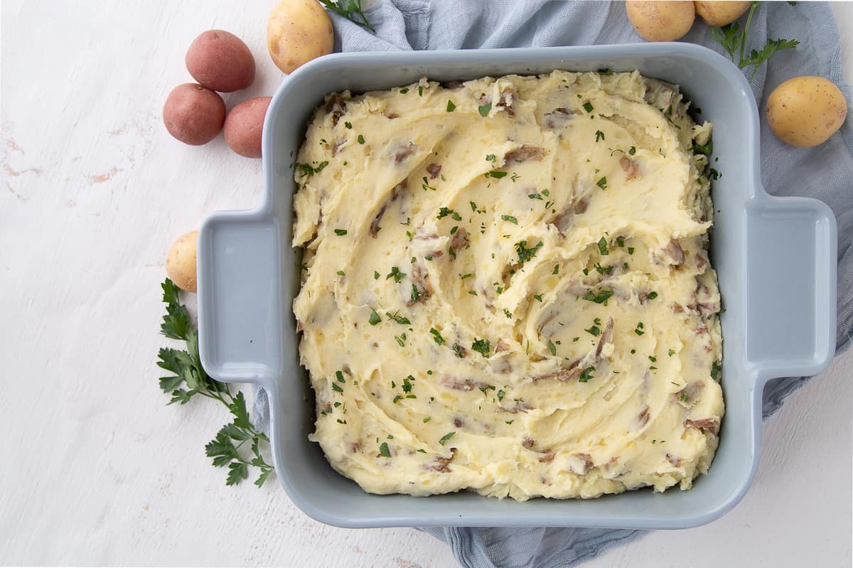 mashed potato casserole in a blue casserole dish.