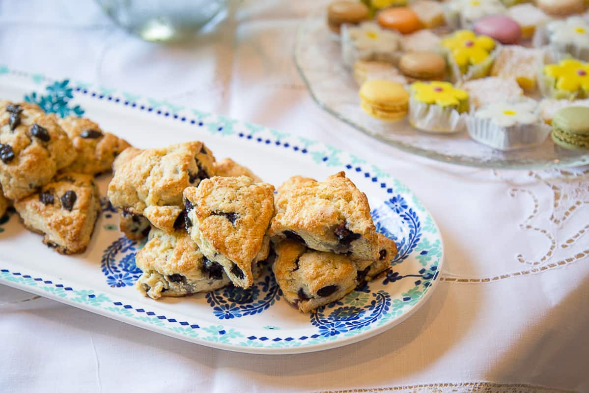 blueberry scones on a white and blue serving platter.