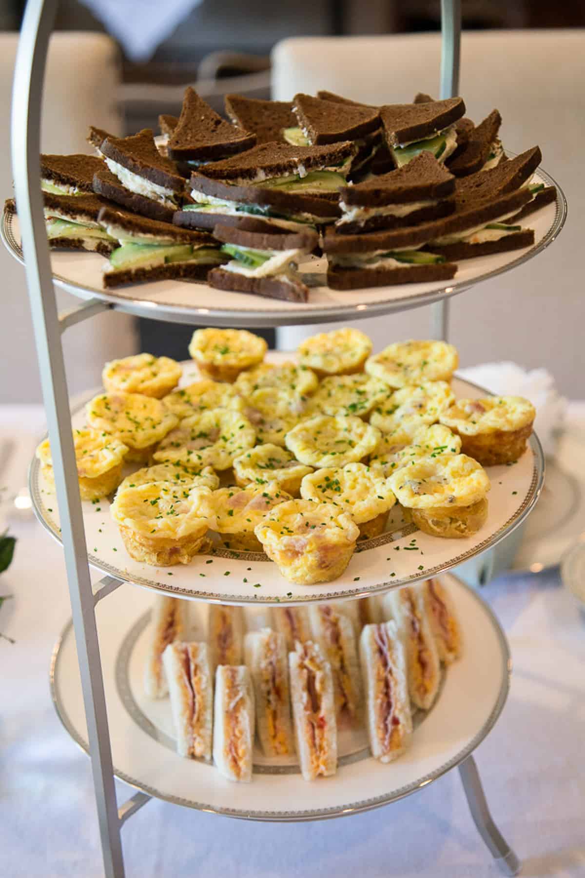 3-tiered platter with tea sandwiches and mini frittatas.