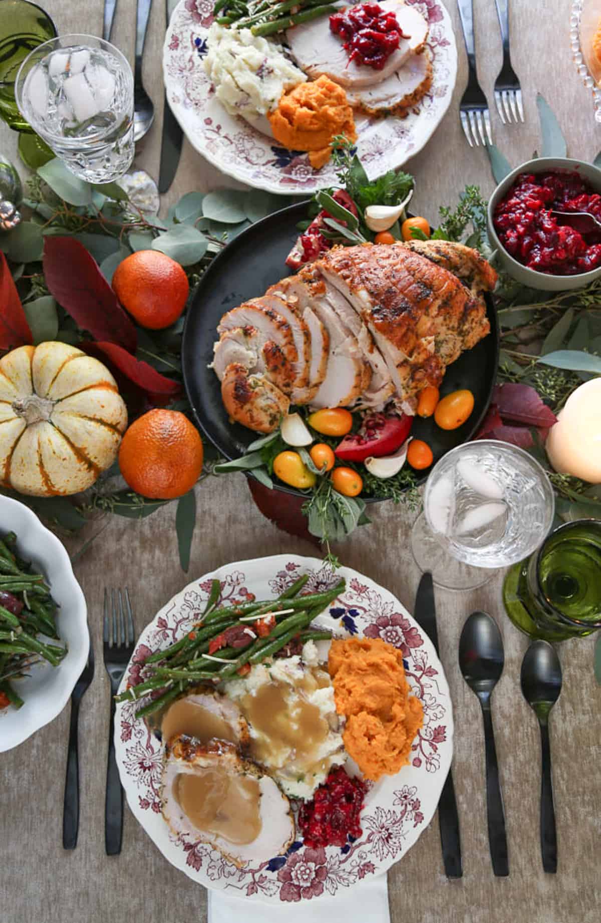 abundant thanksgiving table including a plate filled with thanksgiving food.