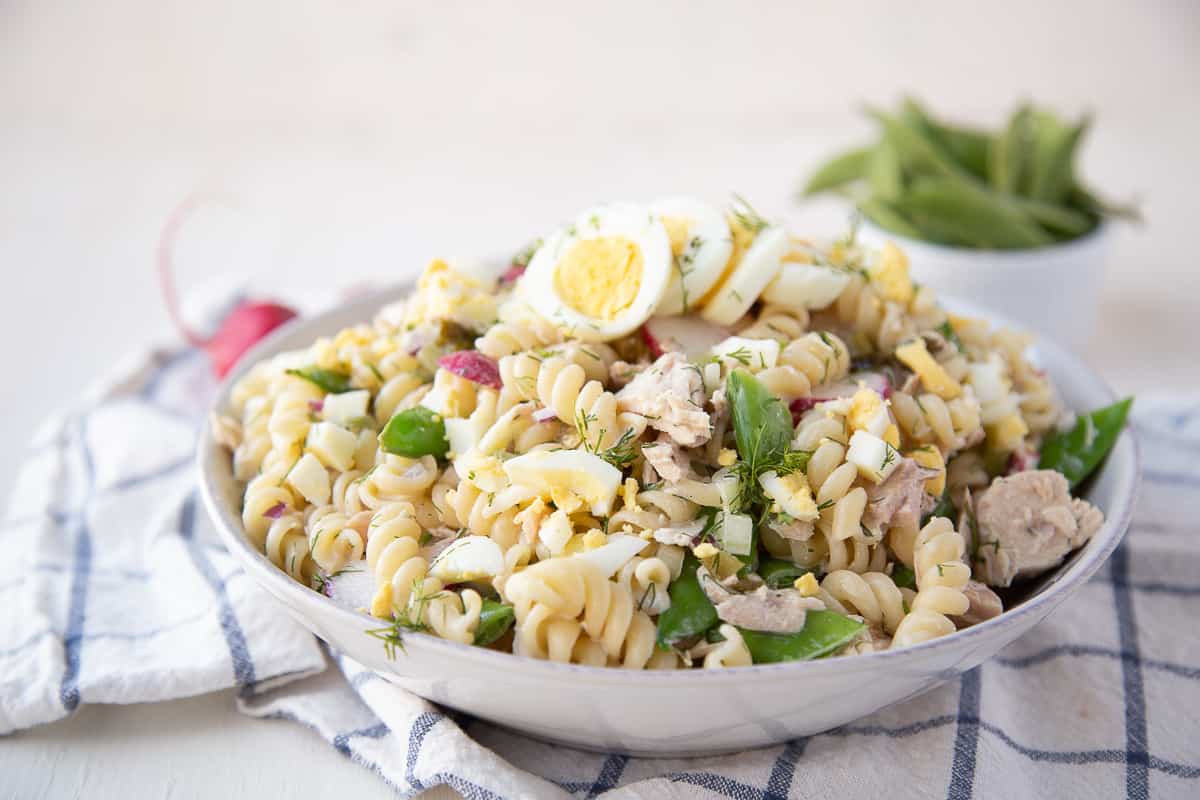 tuna pasta salad sitting on a blue and white tea towel. 