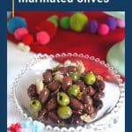 marinated olives in a decorative glass dish.