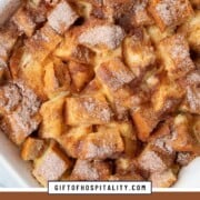 cubes of bread topped with cinnamon sugar in a casserole dish.