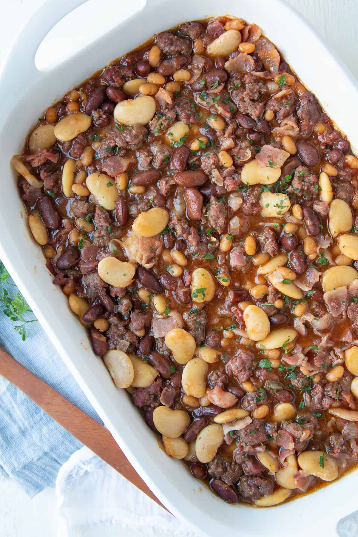 baked calico beans in a large white casserole dish.