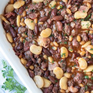 calico baked beans in a white casserole dish.