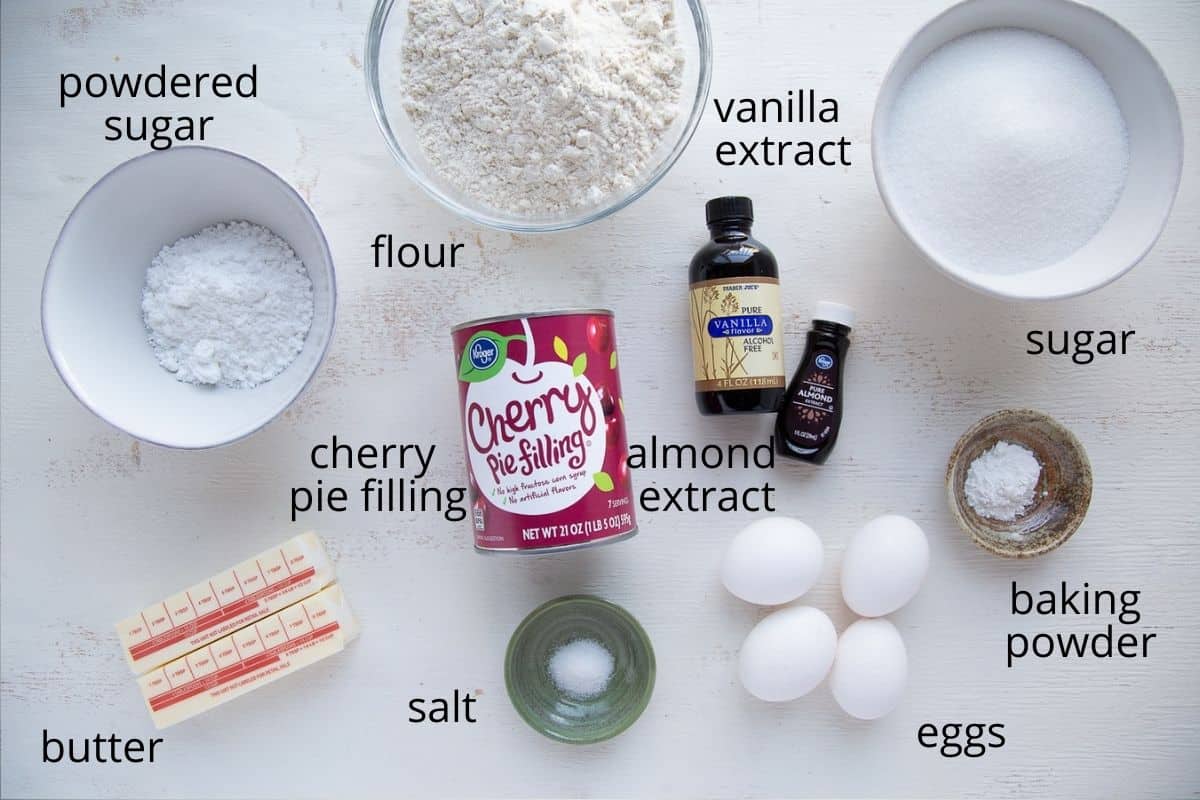 ingredients for cherry coffee cake on a white table.