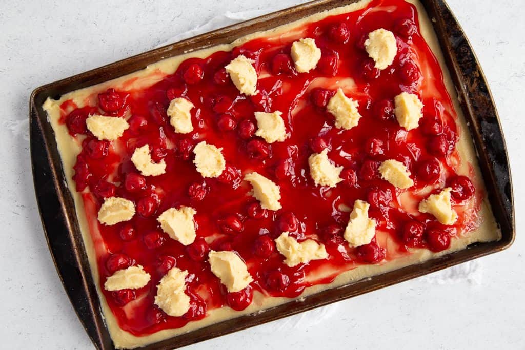 uncooked cherry coffee cake on a white table.
