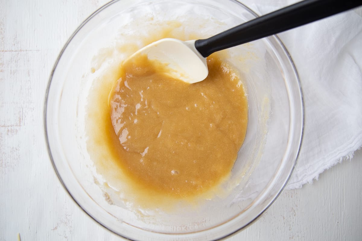 cookie batter in a glass bowl with a spatula.