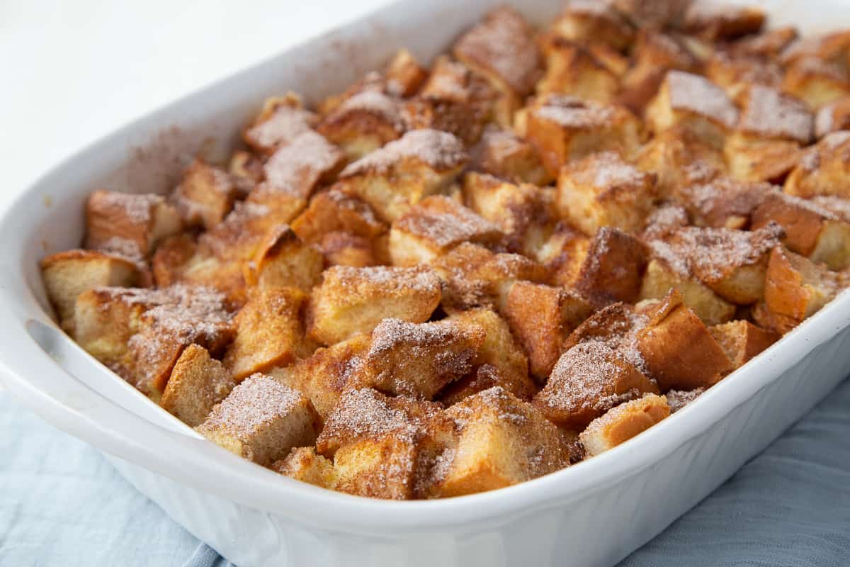 baked french toast casserole in a white casserole dish.