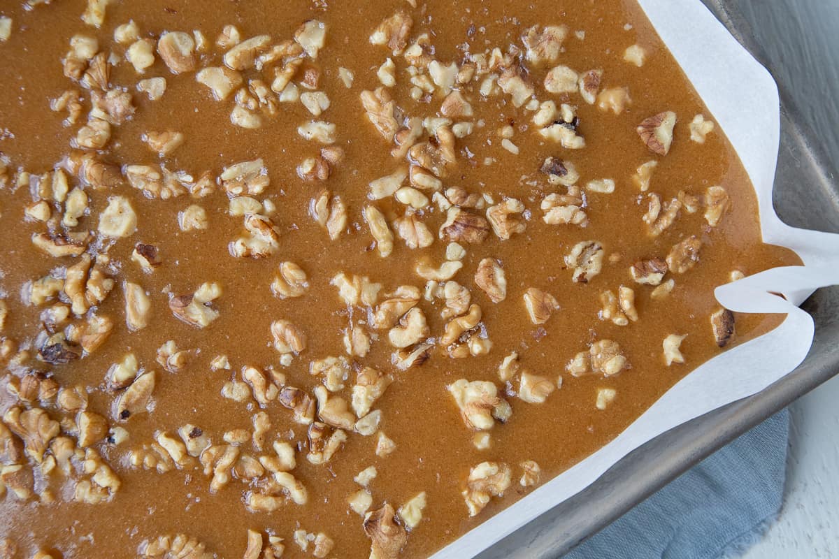 walnut caramels in a metal pan lined with parchment paper.