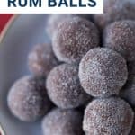 rum balls rolled in white sugar on a white plate.