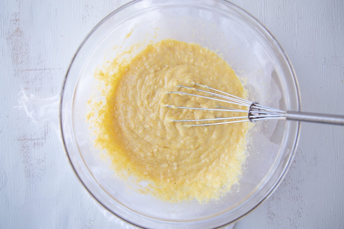 jiffy corn muffin mix, eggs, and butter whisked together in a glass bowl.