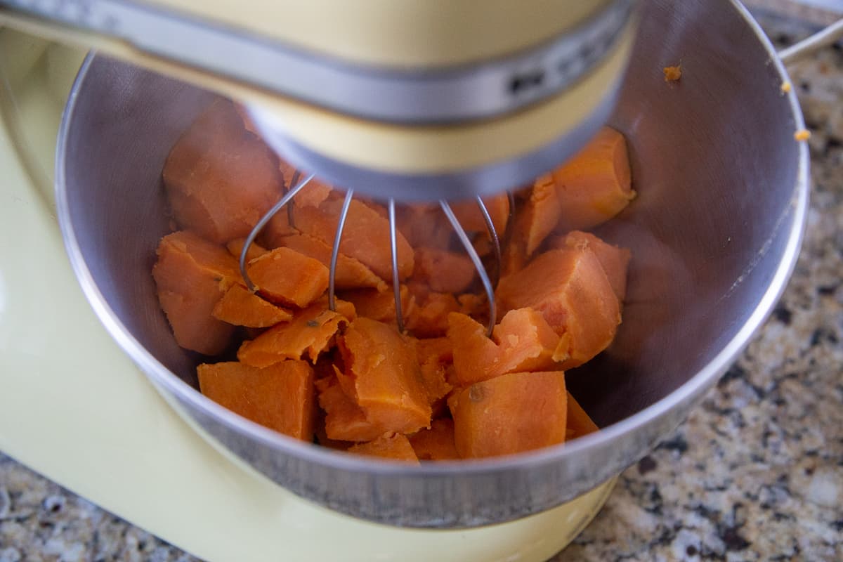 cubed cooked sweet potatoes in the bowl of a stand mixer.