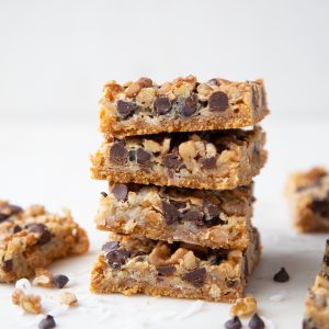 7 layer bars stacked up on a white marble tray.