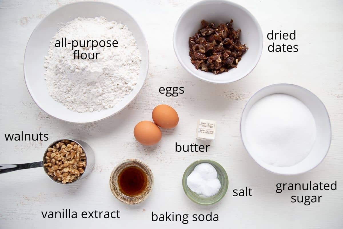 ingredients for date nut bread on a white table.