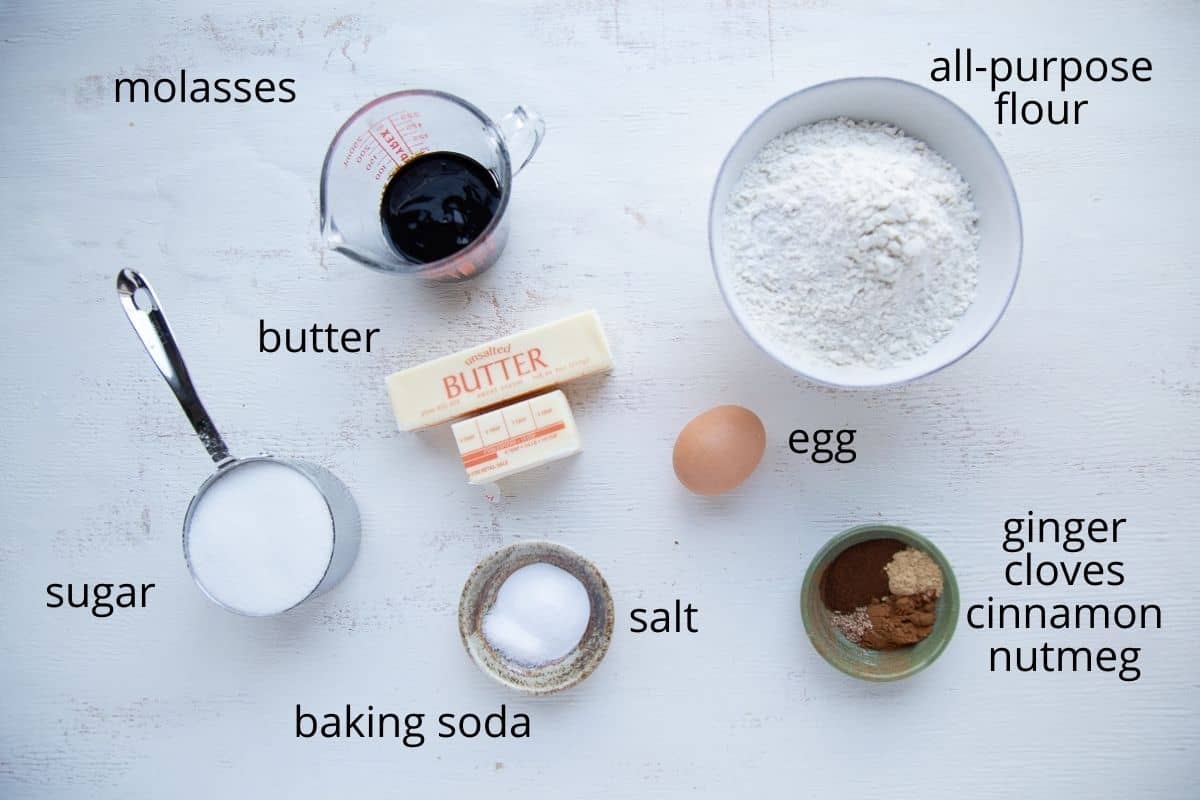 ingredients for ginger cookies on a white table.