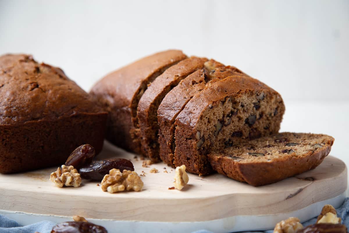 two loaves of date nut bread with slices taken out.