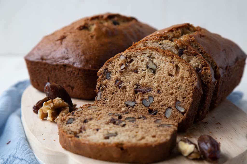 whole loaves of date nut bread with a few slices cut out.