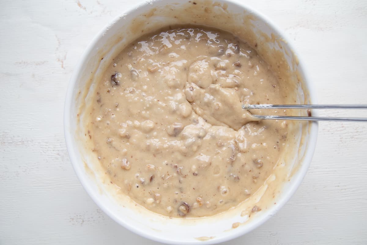 date nut bread batter in a white bowl.