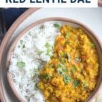 red lentil dal in a brown bowl with rice and cilantro.