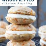 carrot cake whoopie pies stacked on a wire rack.
