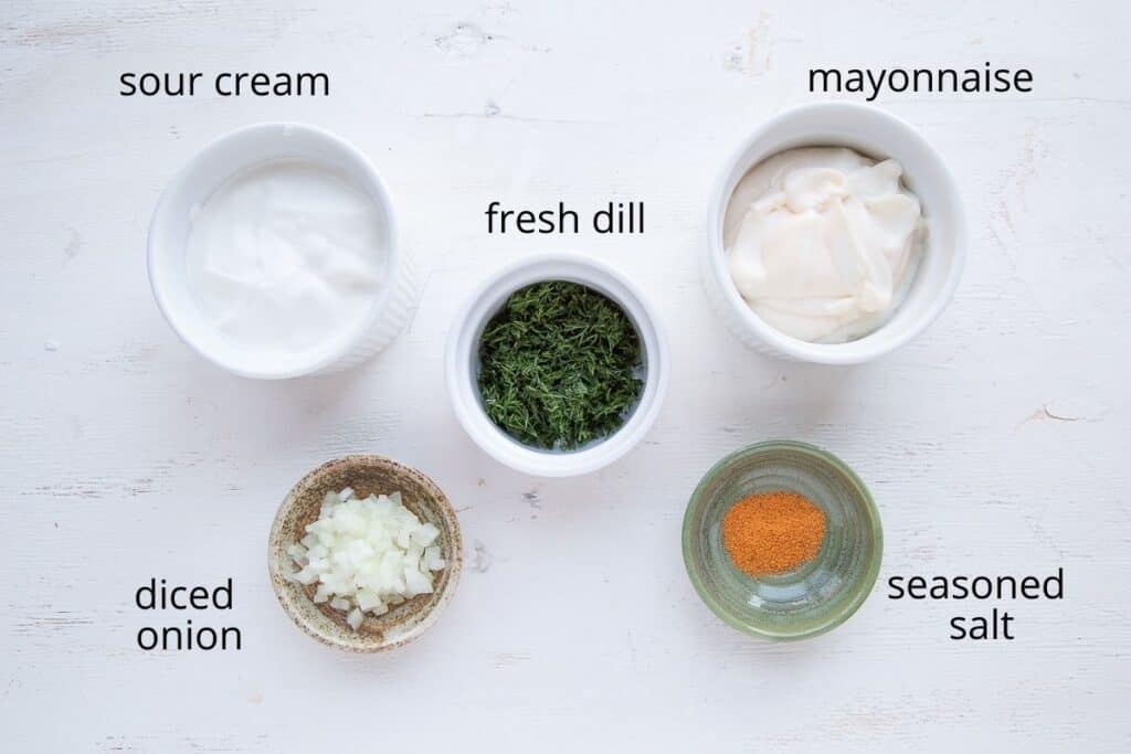 ingredients for dill dip on a white table.