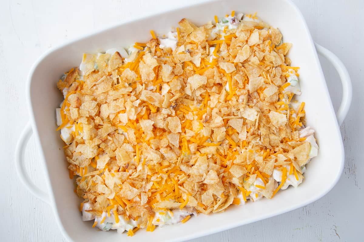 hot chicken salad before baking in a white casserole dish.