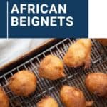 african beignets on a sheet pan with a wire rack.