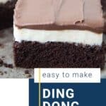 slice of ding dong cake in a cake pan with more ding dong cake in the pan.