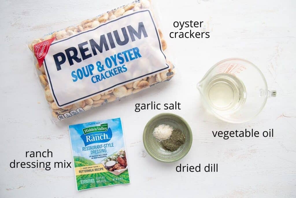 ingredients for ranch oyster crackers on a white table.