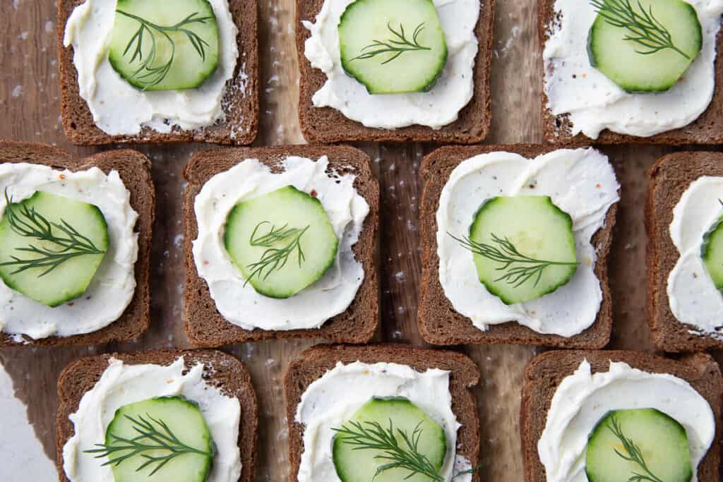 open faced mini cucumber sandwiches on pumpernickel.