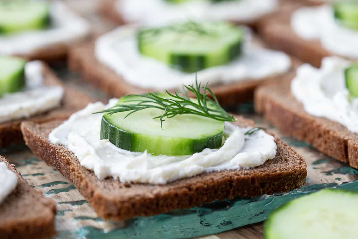 mini cucumber sandwiches on a glass platter.