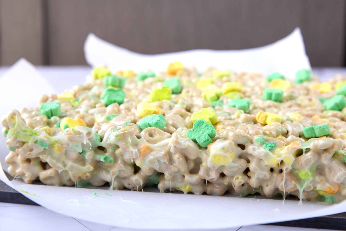 whole pan of lucky charms treats on white parchment paper.