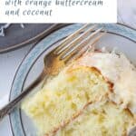 slice of orange cake with coconut on a blue and white china plate with a fork.