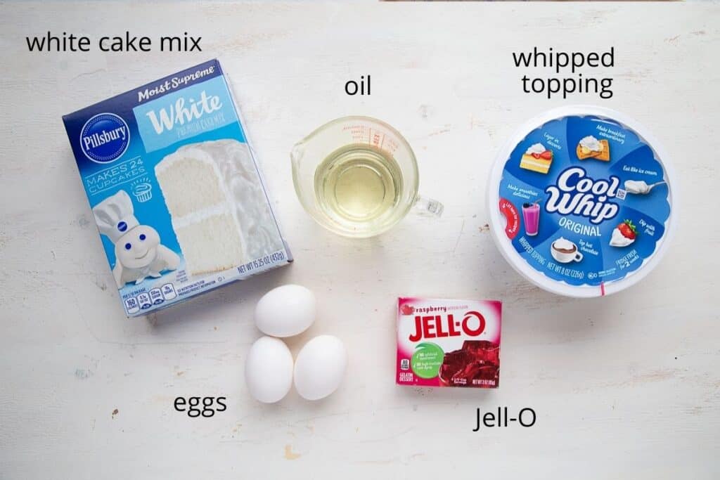ingredients for jello poke cake on a white table.