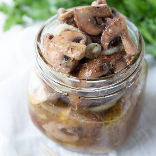 marinated mushrooms in a glass jar.