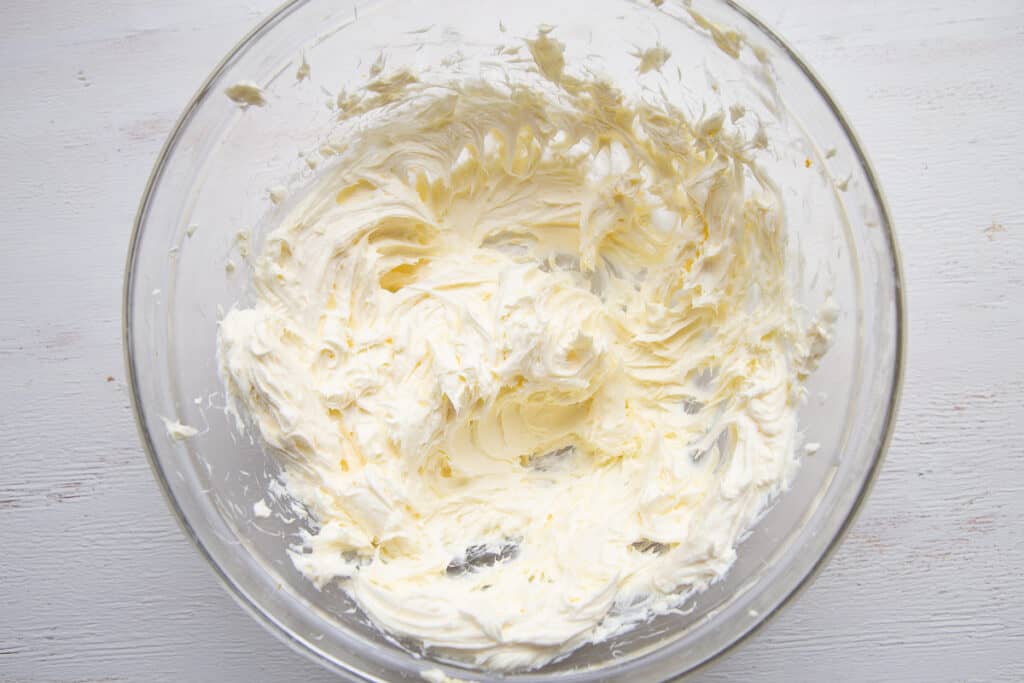 butter and cream cheese beaten together in a glass bowl.