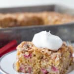 slice of rhubarb cake on a white plate.