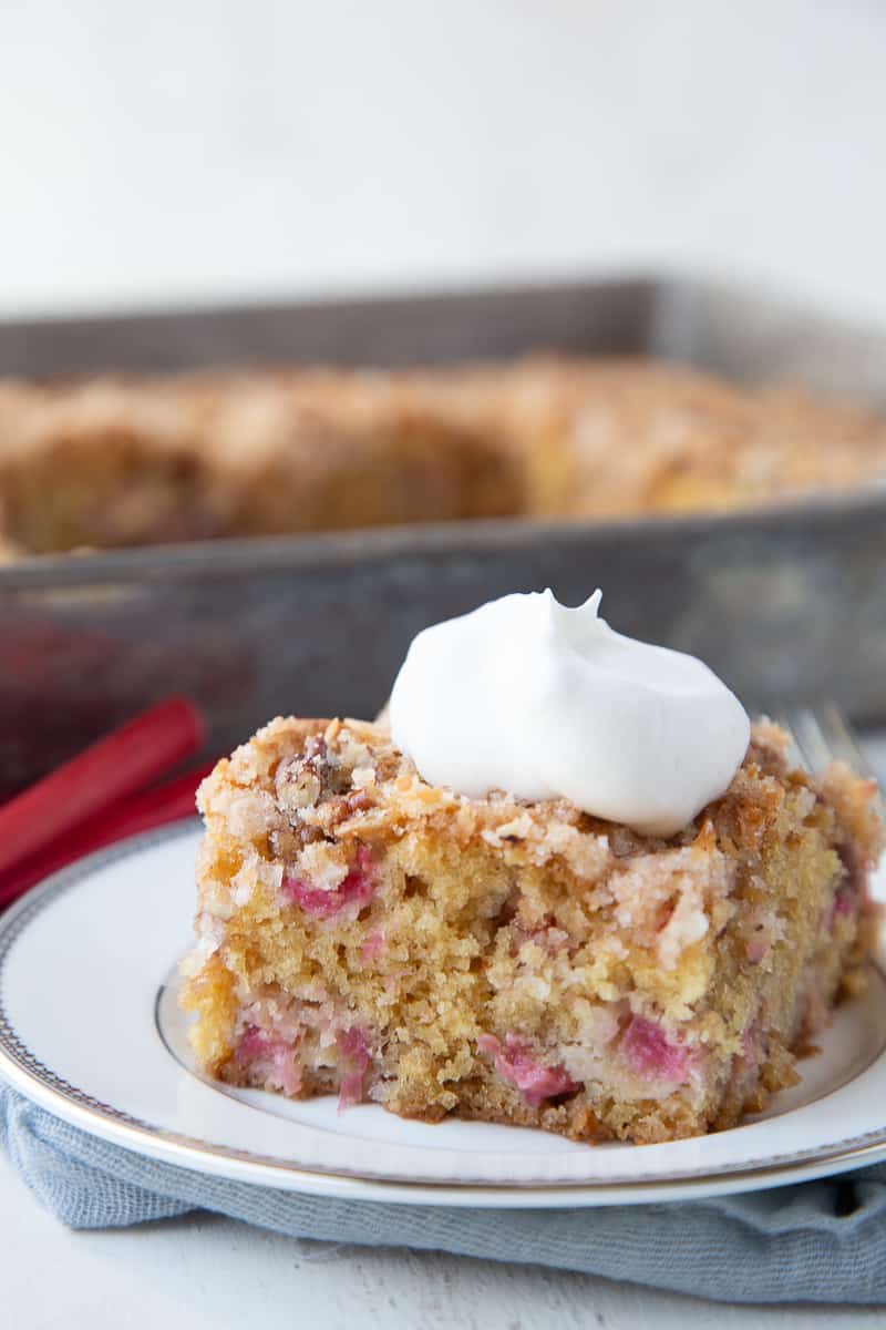 slice of rhubarb cake on a white plate.