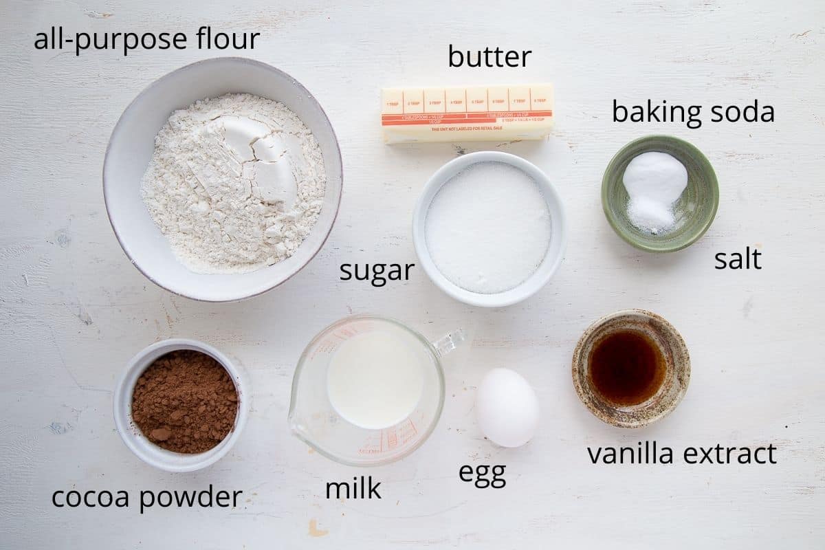 ingredients for chocolate marshmallow cookies on a white table.