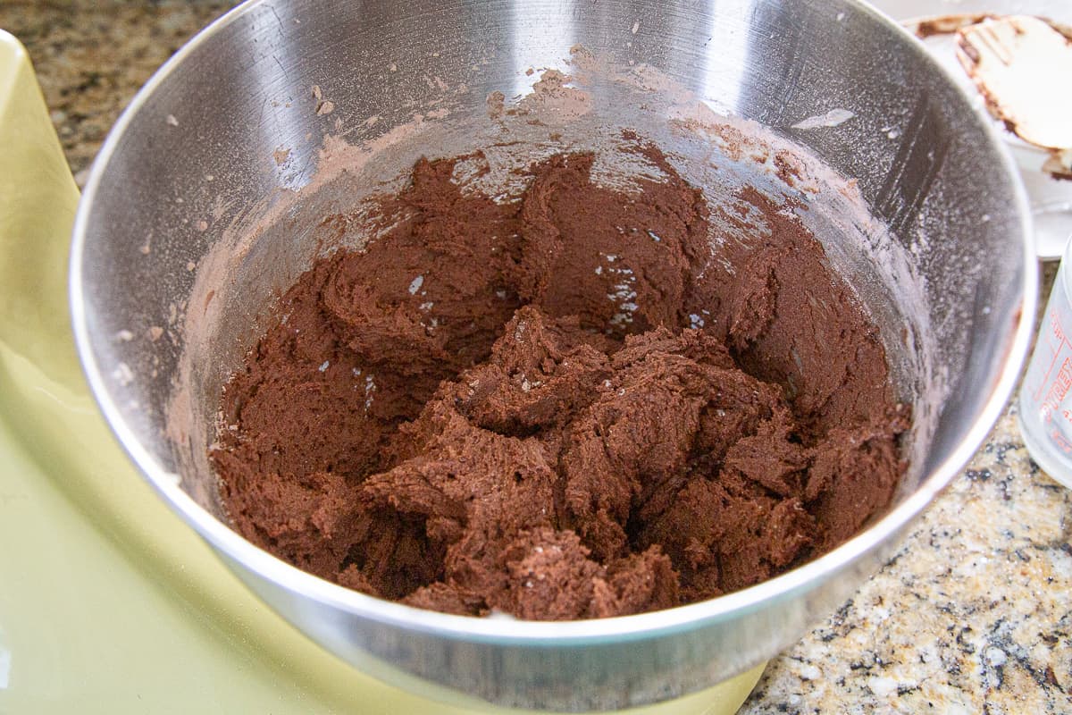 chocolate cookie dough in the bowl of a stand mixer.