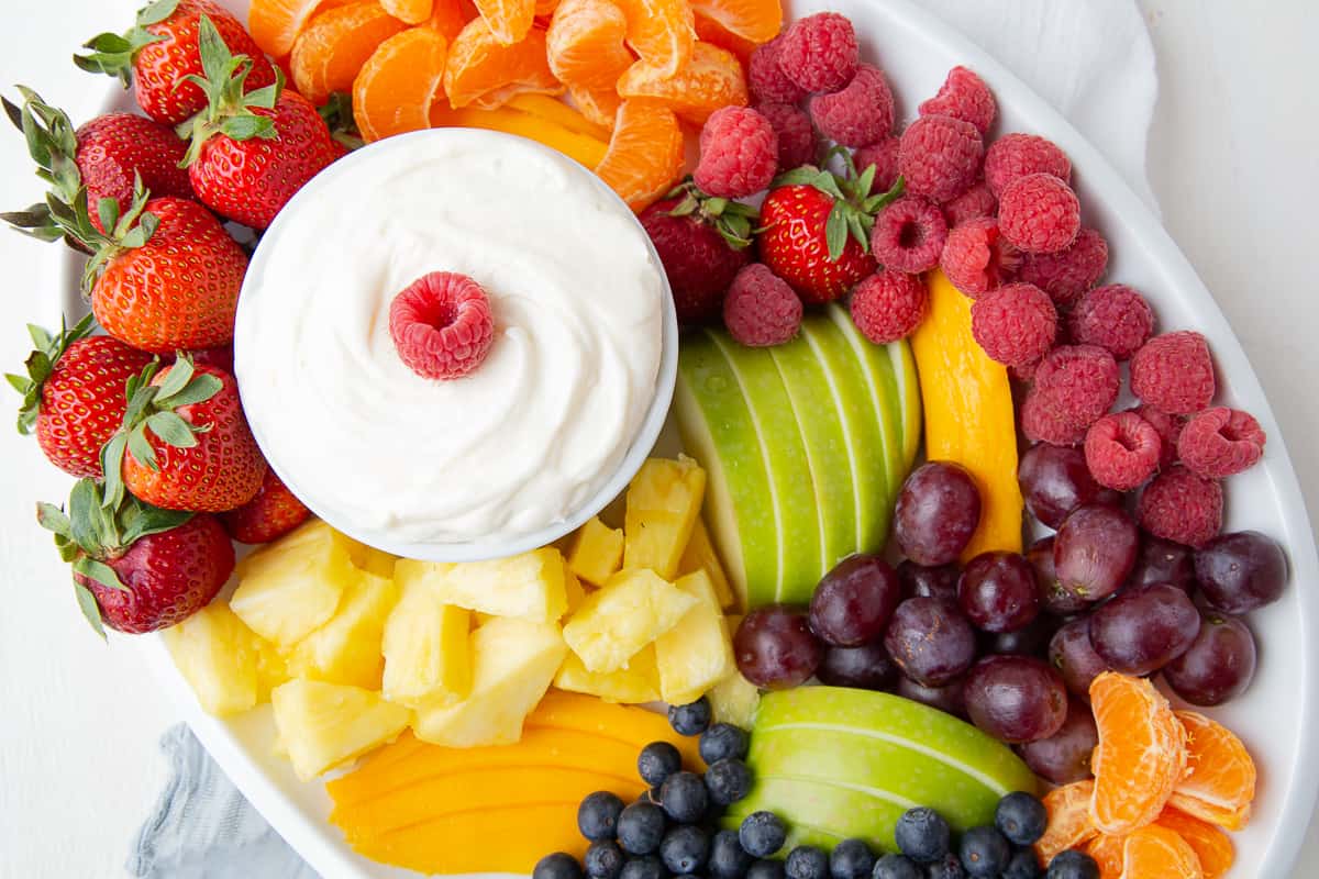 fruit platter with a bowl of fruit dip in the middle.