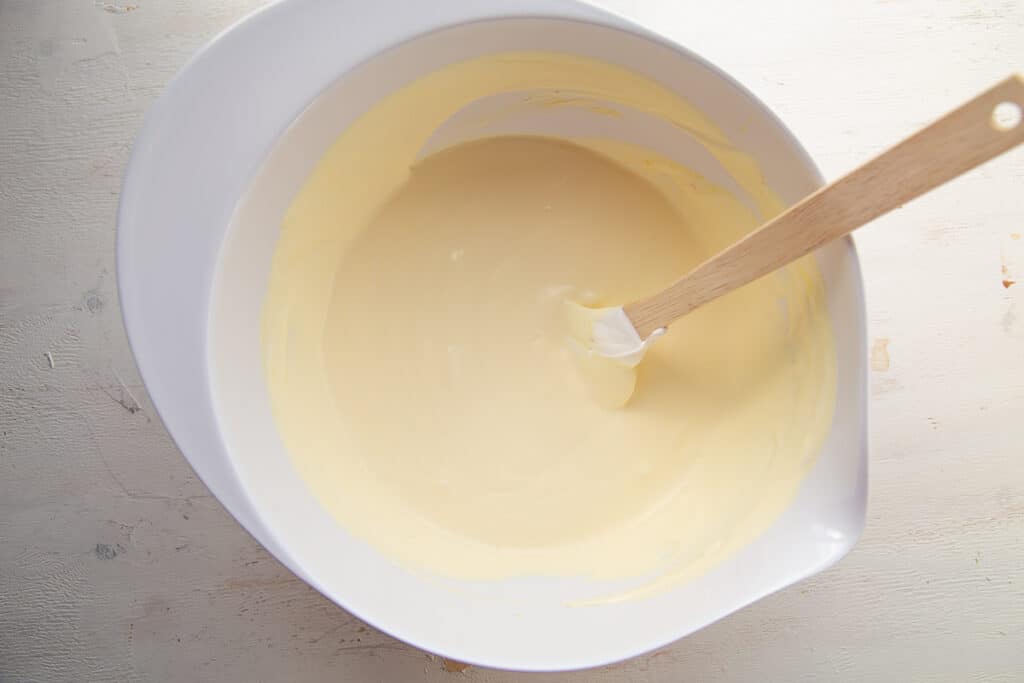 jell-o pudding in a mixing bowl with a spatula.