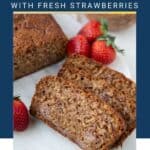 slices of strawberry bread on a white platter next to whole strawberries.