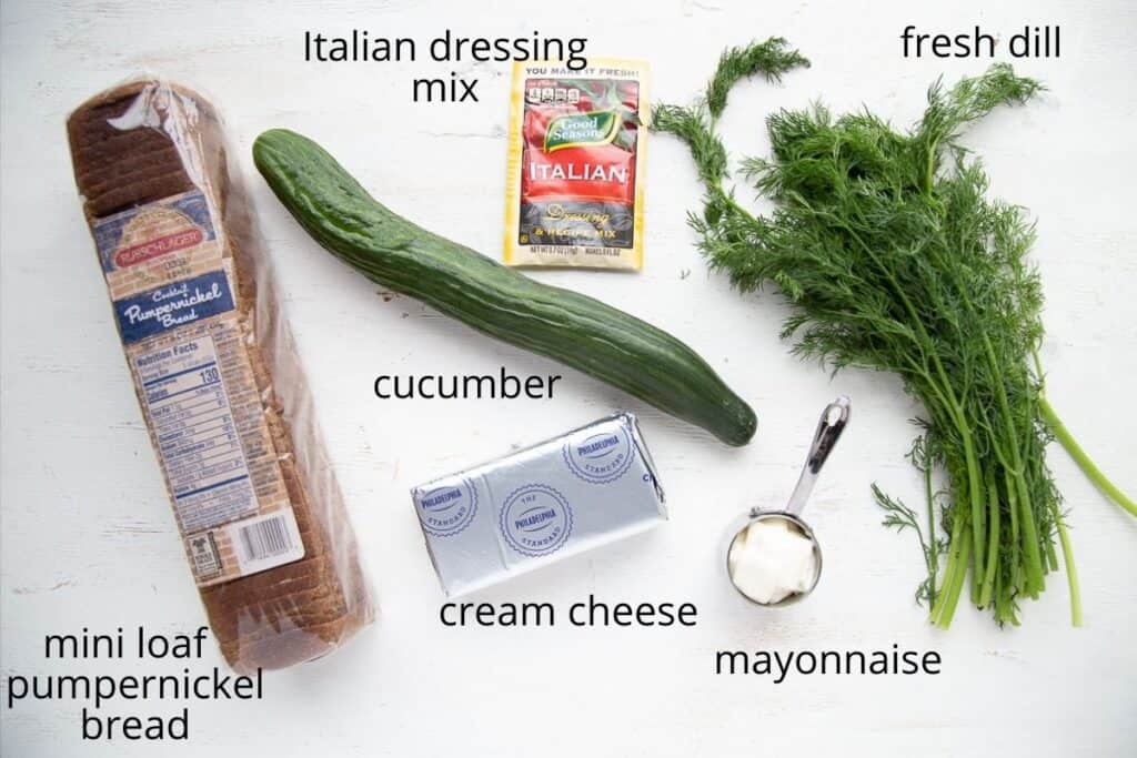 ingredients for cucumber sandwiches on a white table.